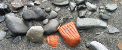 A textured brick among 

smooth rocks